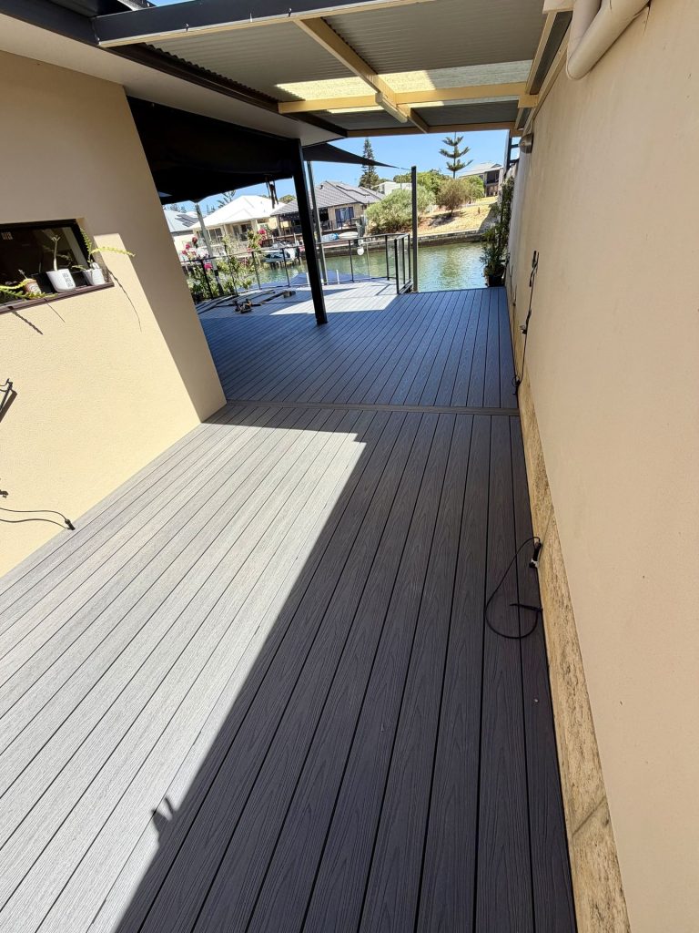 Composite deck running down a side alfresco beside a limestone retaining wall
