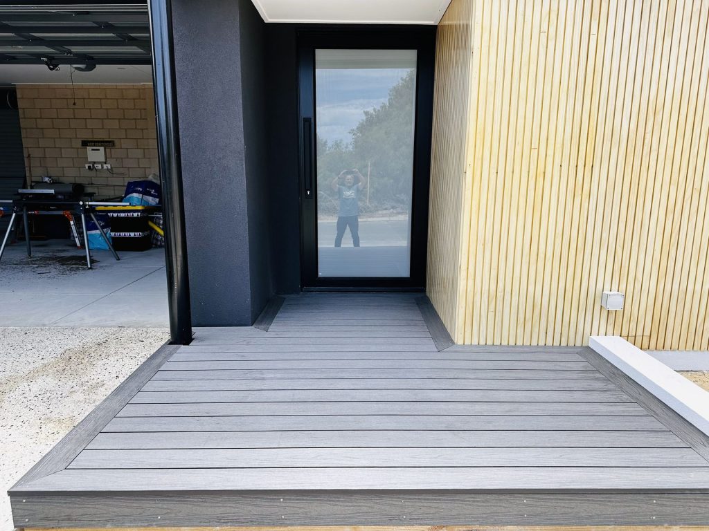 Grey composite entry deck with a picture frame border at a Mandurah front door