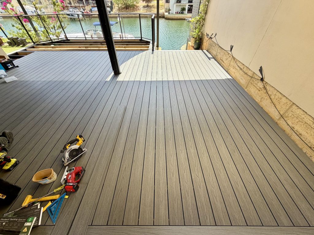 Ekodeck Alpine Ash composite decking being installed on a canal-front alfresco in Mandurah