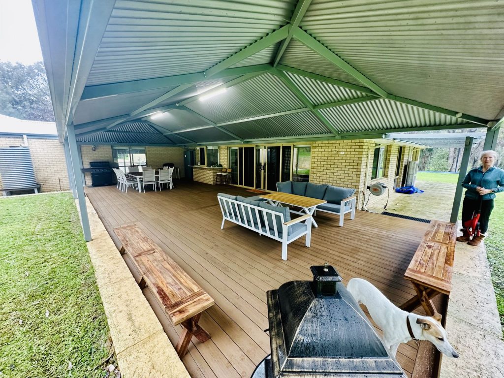 Gable roof patio with composite decking and a limestone retaining wall