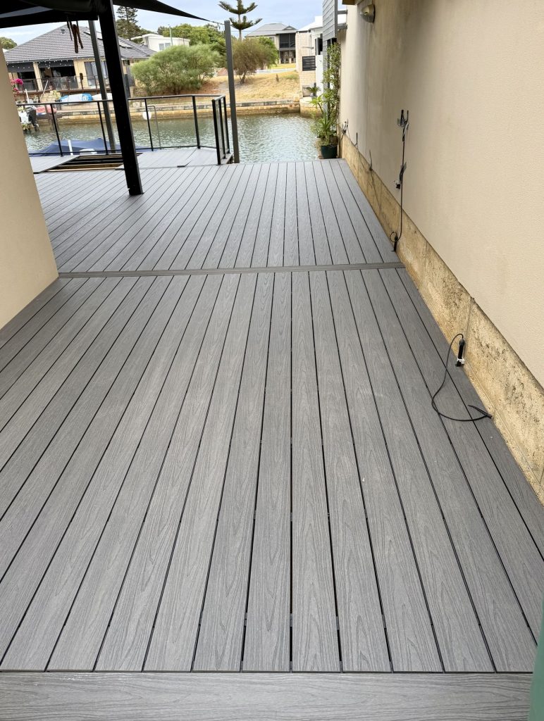 Grey composite alfresco deck with a breaker board running to the canal in Mandurah