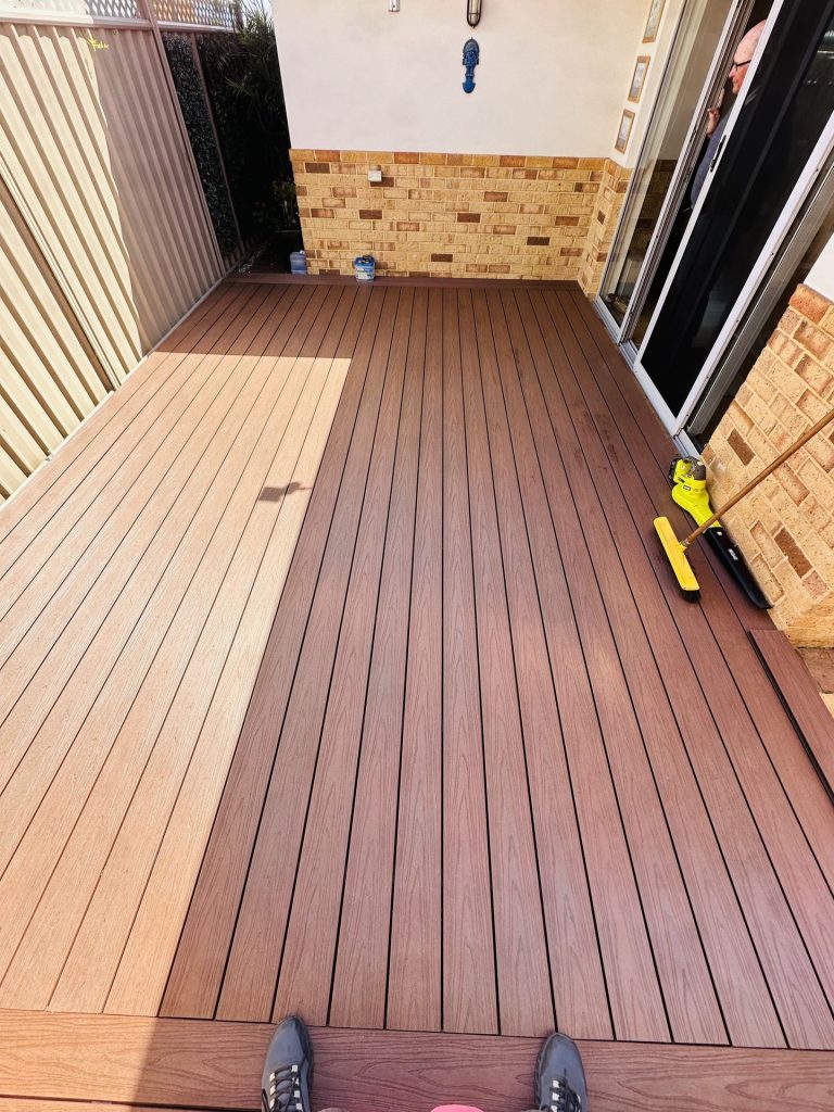 Red-brown composite courtyard deck outside a sliding door in Mandurah